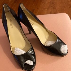 Black leather platform heels with peep toe.